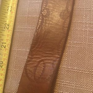 Genuine leather belt with turquoise belt buckle.